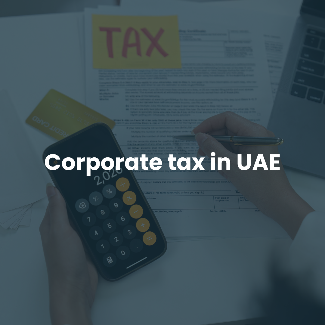 Business owner calculating corporate tax in UAE using calculator and documents, representing UAE corporate tax compliance, registration and tax planning.