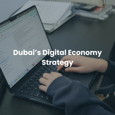 Person using laptop with text “Dubai’s Digital Economy Strategy” representing UAE digital business growth.
